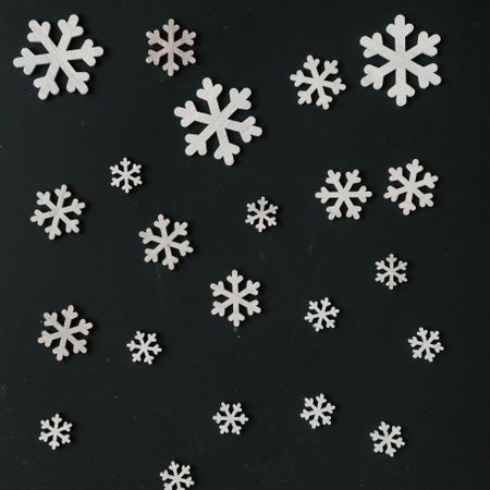 Creative pattern made of snowflakes on dark chalkboard