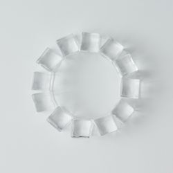Ice cubes in circle on bright background