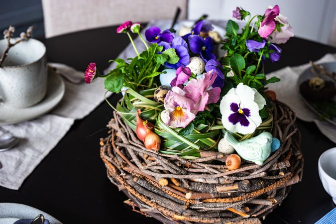 Easter table setting with centerpiece of giant nest and flowers