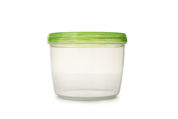 Plastic container with green cap isolated on light background