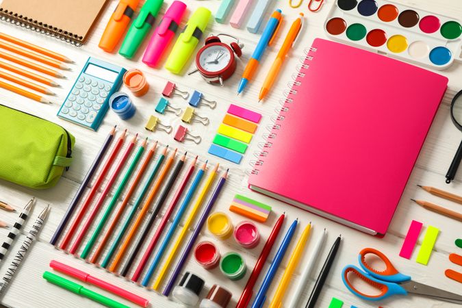 Flat lay composition with school supplies on wooden background