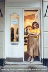 Businesswoman standing at entrance of her store looking at camera with her arms crossed 5ojo90