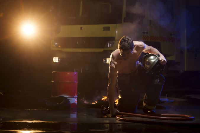 Muscular firefighter on mission