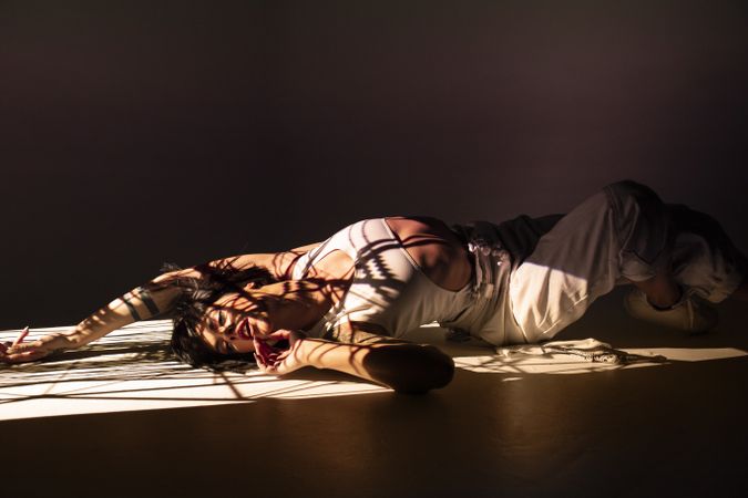 Woman dancing under bright light