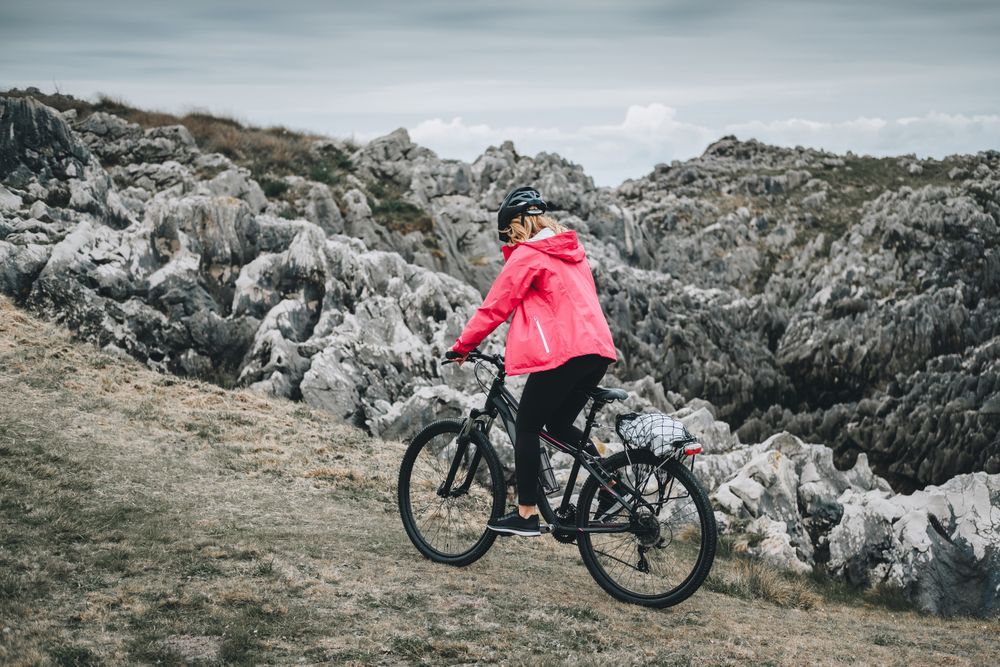 Female cyclist riding on mountain road