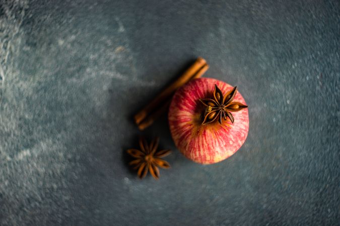 Top view of apple on table with star anise and cinnamon stick