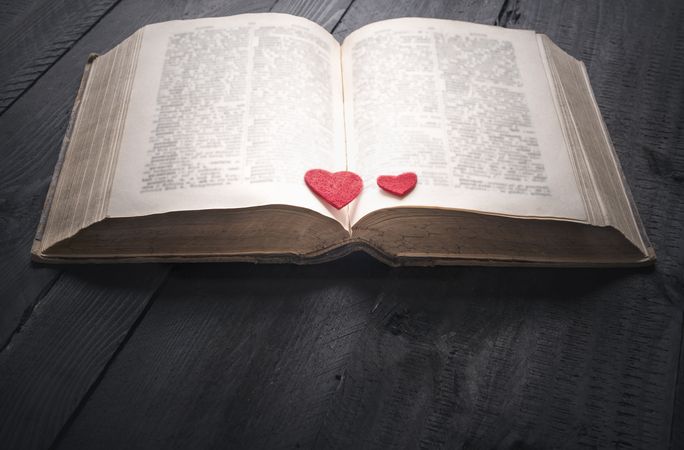 Two red hearts on an open book