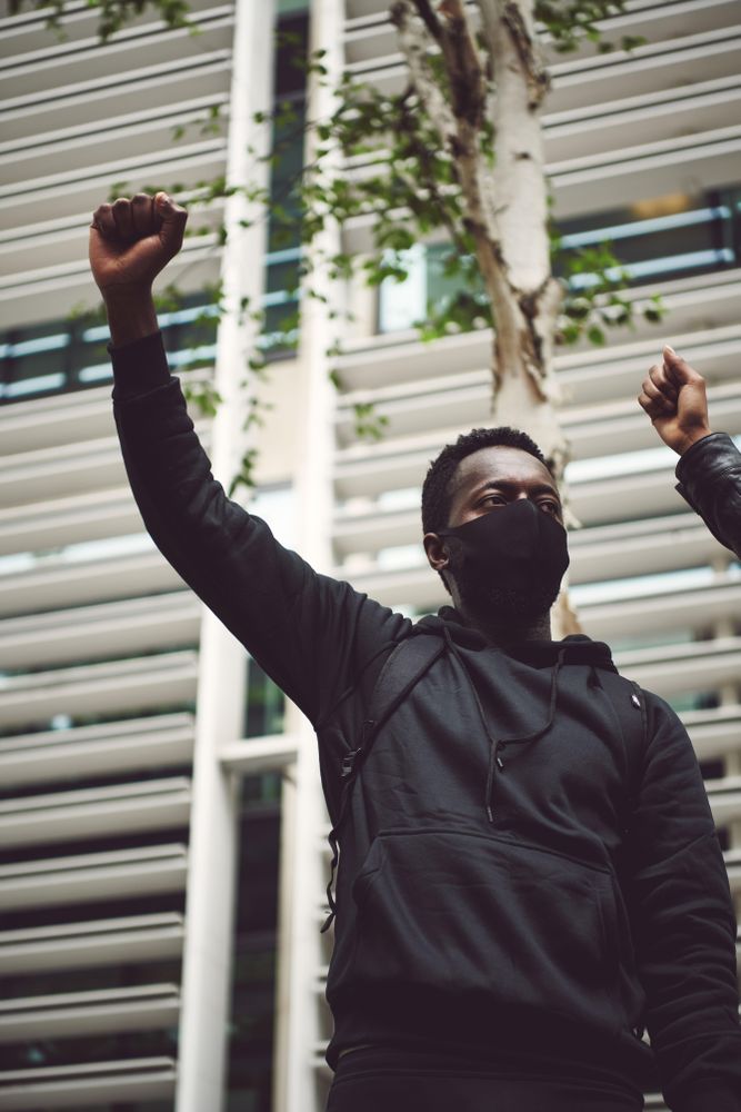 London, England, United Kingdom - June 6th, 2020: Man in face mask with raised fist