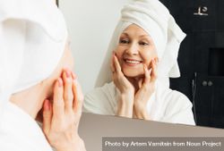 Cheerful woman admires her reflection in the bathroom mirror 5wEQLb