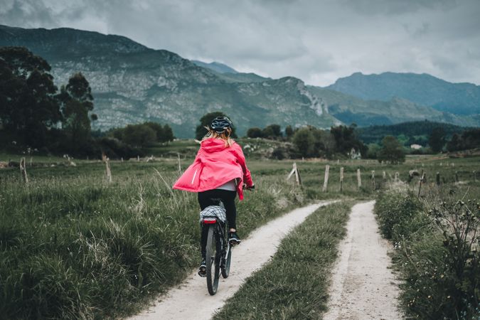 Female cyclist riding on mountain road