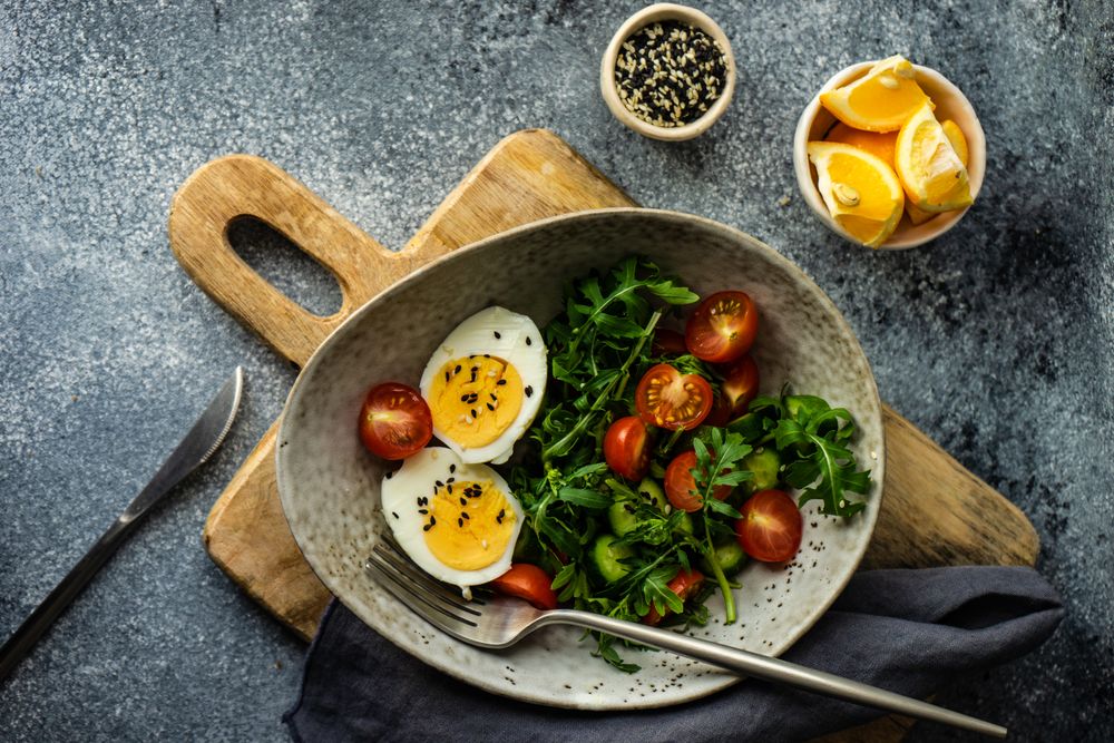 Top view of healthy salad with hard boiled egg