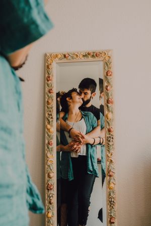 Romantic couple reflecting in rustic mirror