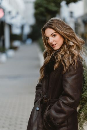 female standing on city street