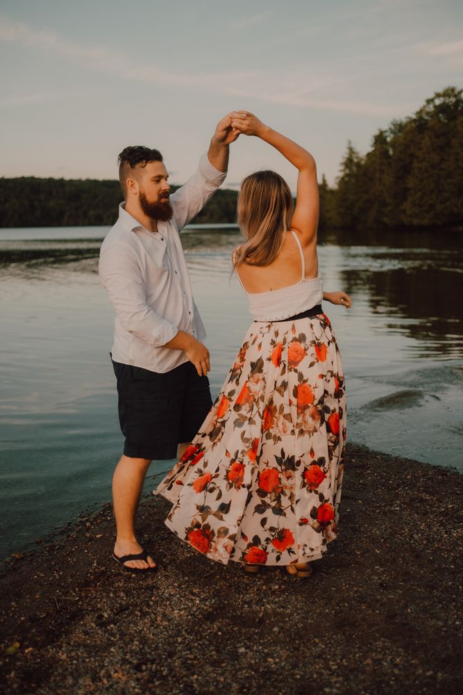 Loving couple standing ankle deep in water on beach