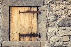 Wooden trap door with rusty hinges