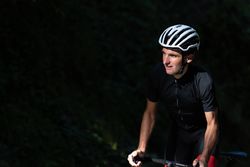 Professional cyclist riding bike in park