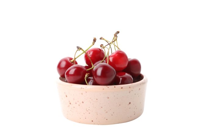ripe cherry fruits in a bowl, isolated on blank background
