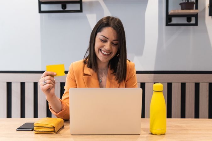 Happy woman making payment during online shopping