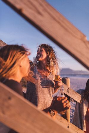 Happy young woman with a drink outdoors