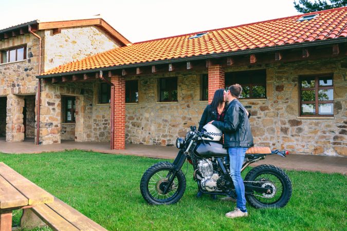 Couple kissing with custom motorcycle