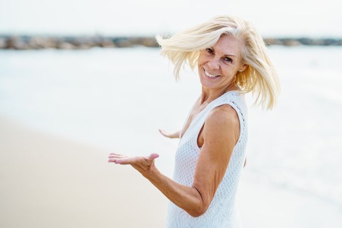Smiling mature woman with her hair blowing in the wind