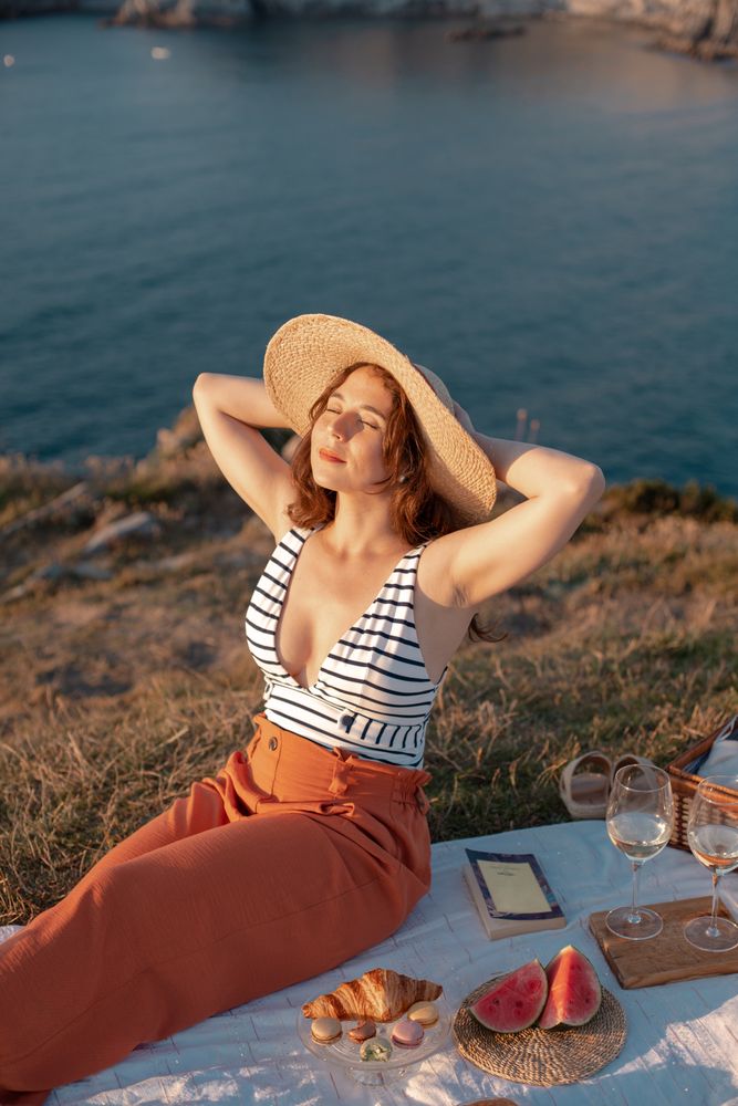 Woman resting in meadow on picnic