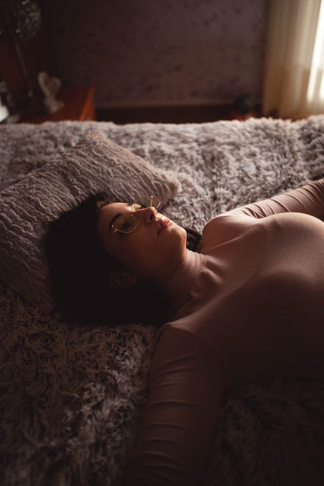 Young woman lying on bed