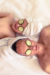 Mother and son with cucumber on eyes