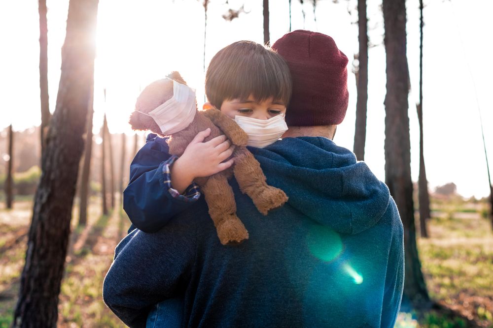 Father holding son in wood