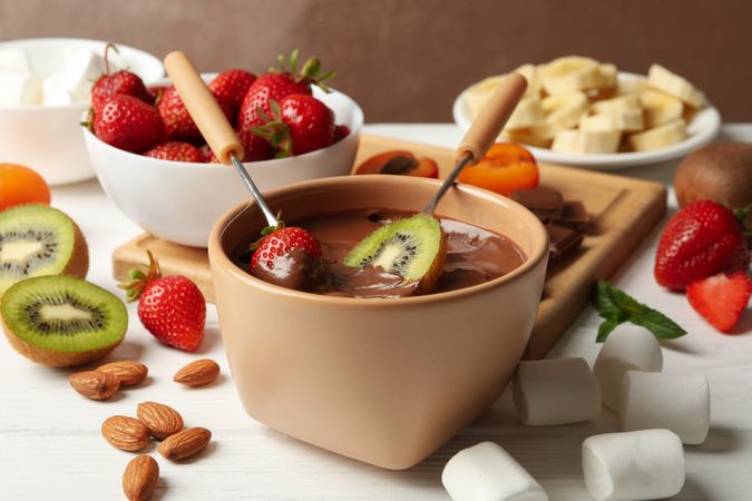 Composition with ingredients for chocolate fondue on wooden background. Cooking fondue