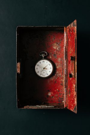 Open box with red interior and clock