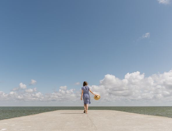 Young woman on sea wharf