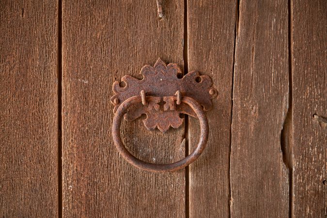 Metal old handle on wooden door