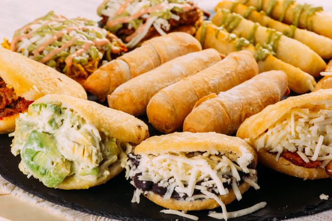 Venezuelan food tasting dish, the dish has arepas, tequeños, yuca and patacones