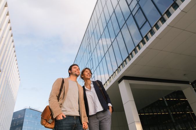 Businesspeople couple outside contemporary building
