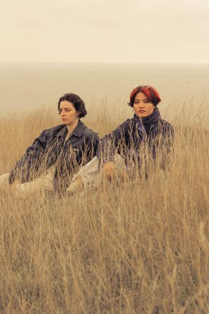 Two women posing in field of long brown grass