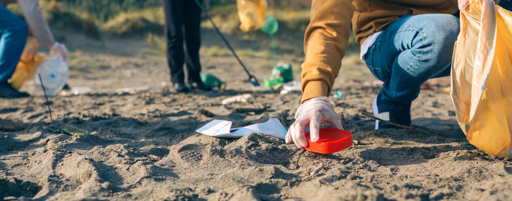 Young man cleaning the beach