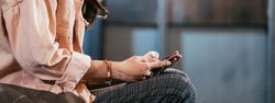 Banner of person sitting and enjoying playing on mobile phone