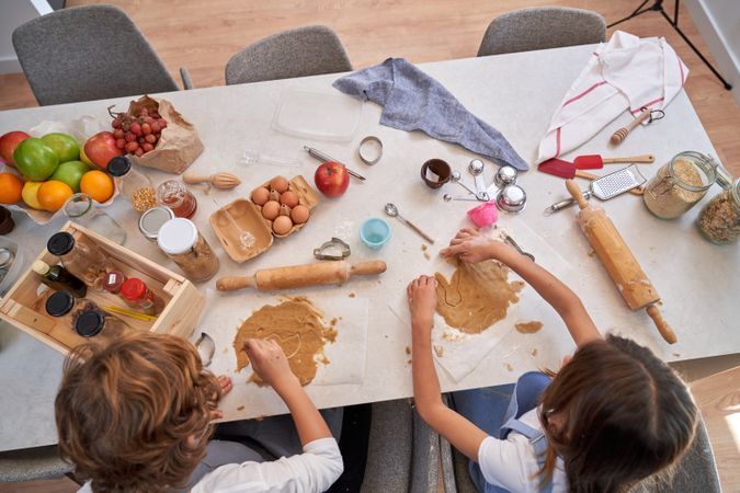 Unrecognizable children making cookies on table