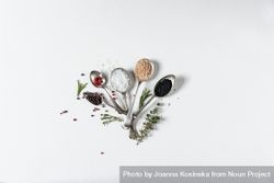 Spoons of salts, spices and herbs on light background 0gXGRM