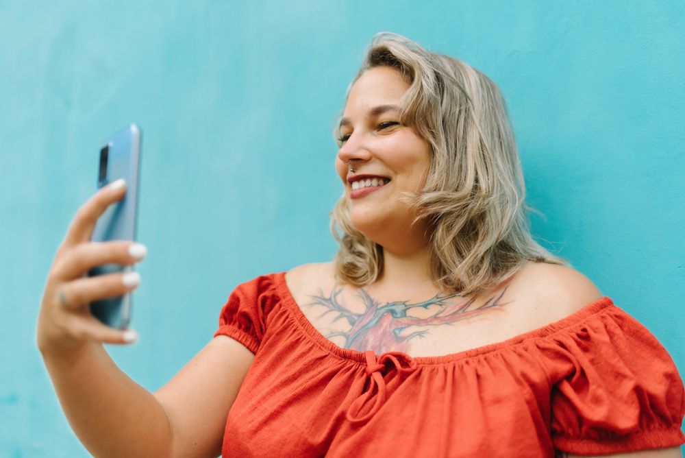Young woman taking selfie on smartphone