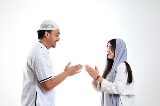 Asian Couple Forgiving Each Other by Giving Greets Hand During Eid Mubarak Celebration