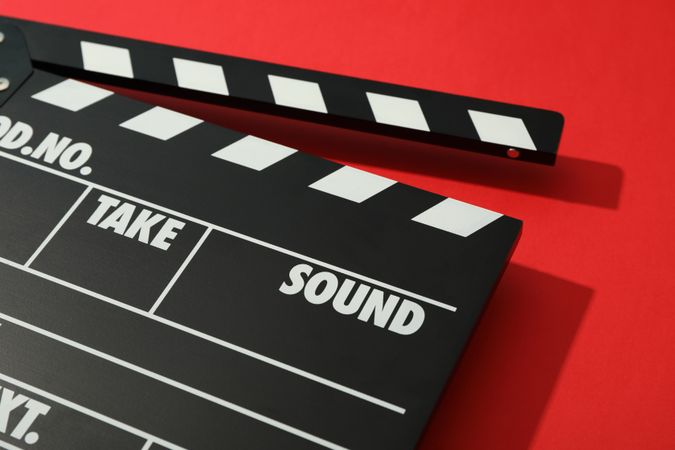 clapperboard on red background, space for text