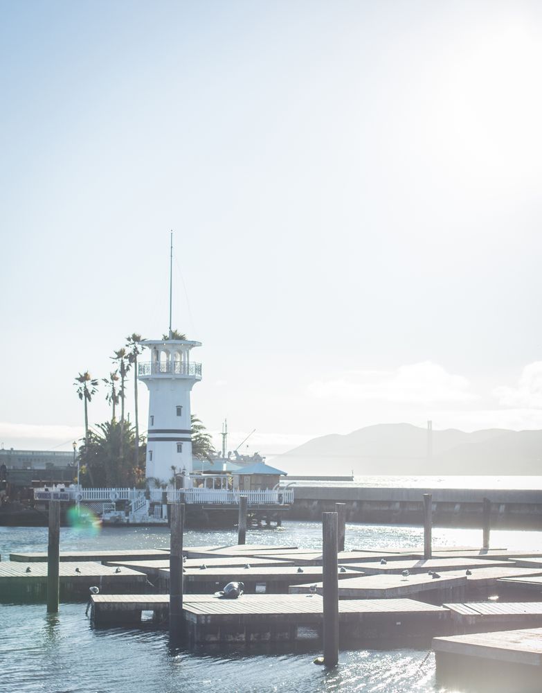 Beacon near embankment of sea in sunny weather