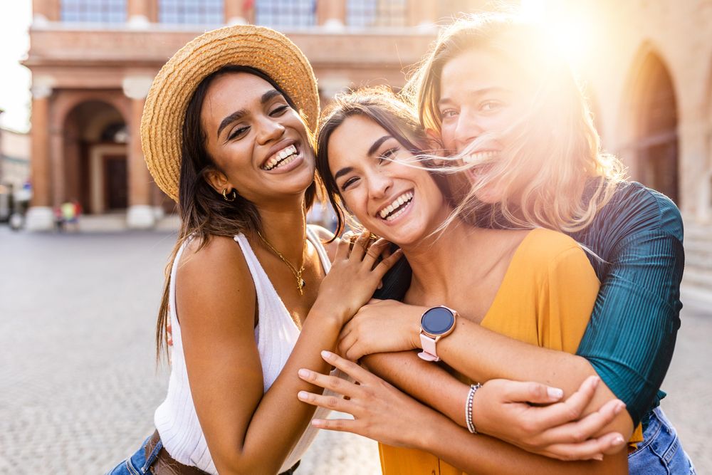 Smiling multi-ethnic female having fun on summer holidays in city street