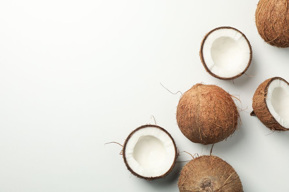 Flat lay with coconut on plain background, top view