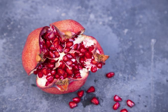 Ripe pomegranate fruit on dark background, closeup