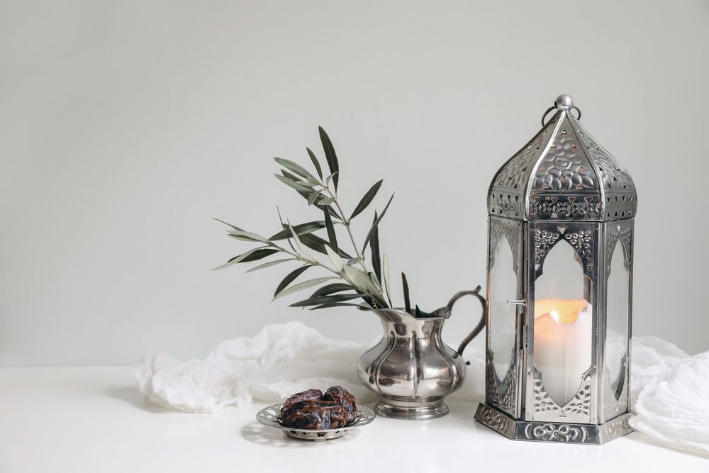 Glowing ornamental lantern with olive tree branch
