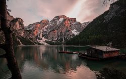 Houseboat surrounded with mountains on serene lake