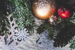 Christmas card concept or snow flakes on pine branch with baubles
